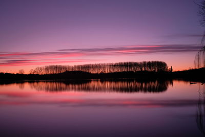 Scenic view of lake against romantic sky at sunset