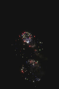 Low angle view of firework display against sky at night