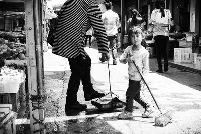 Low section of woman standing on street