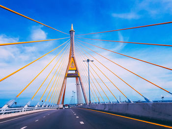 Low angle view of suspension bridge against sky