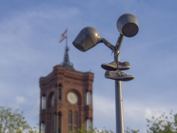 Low angle view of street light against building