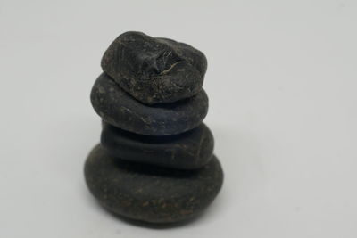 Close-up of stone stack against white background