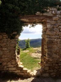 View of stone wall with trees in background