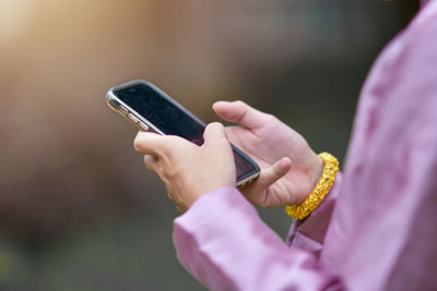 Close-up of man using mobile phone