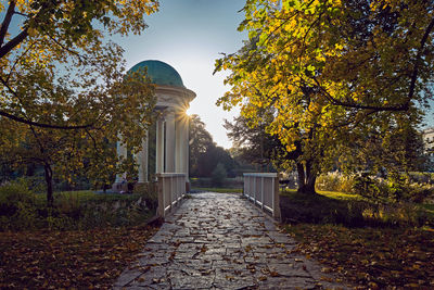 Footpath amidst trees in park during autumn