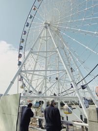 Low angle view of ferris wheel against sky