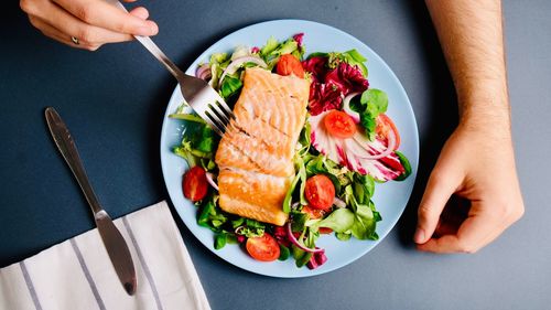 High angle view of person holding food on table