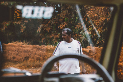 Portrait of smiling man sitting in car