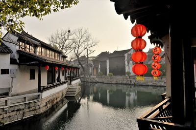 Reflection of building in canal against sky