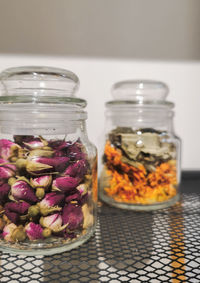 Close-up of flowers in glass jar on table