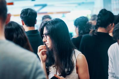 Businesswoman standing with coworkers in office