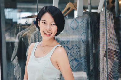 Portrait of smiling young woman standing in store