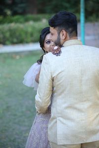 Rear view of couple standing outdoors