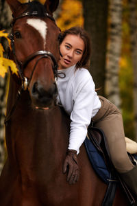 Portrait of young woman riding horse