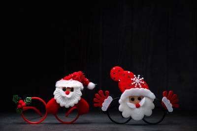 Close-up of christmas decorations against black background