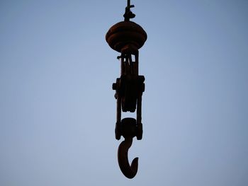 Low angle view of silhouette lighting equipment against clear sky