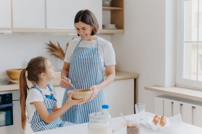 Girl and woman standing on table