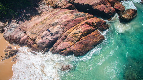 High angle view of rock formations by sea