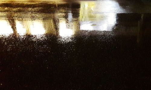 Reflection of raindrops on puddle