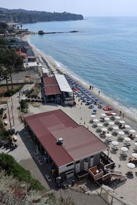 High angle view of beach by buildings against sky