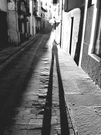 Rear view of woman walking on road