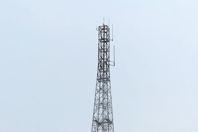 Low angle view of electricity pylon against clear sky