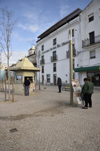 People walking in front of building