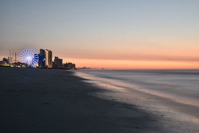 Scenic view of beach against sky during sunset