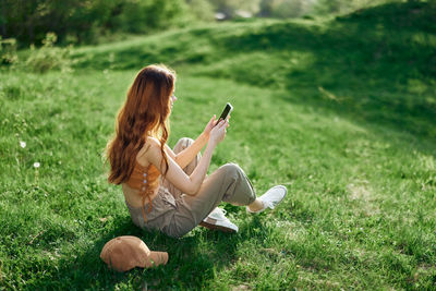 Side view of woman using mobile phone