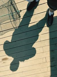 Low section of people standing on sunny day