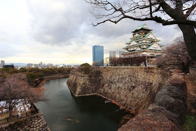 View of bridge over river against buildings