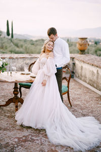 Rear view of couple holding hands