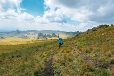 A hiker doing yoga against rock formations at the la satima dragons teeth in the aberdares, kenya