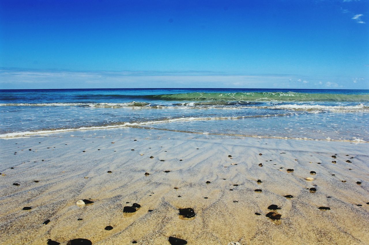 beach, sea, horizon over water, sand, water, shore, tranquil scene, tranquility, scenics, beauty in nature, sky, blue, nature, idyllic, coastline, wave, calm, remote, copy space, outdoors