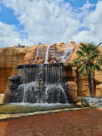 View of fountain against cloudy sky