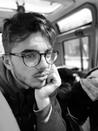 Thoughtful teenage boy sitting in bus