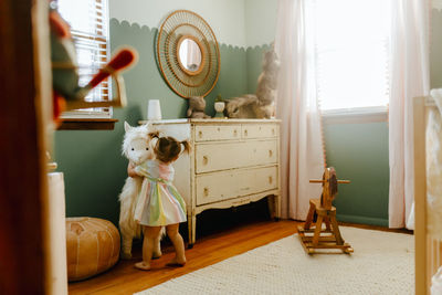 Girl hugging her stuffed animal in her room