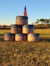 Built structure on field against clear blue sky