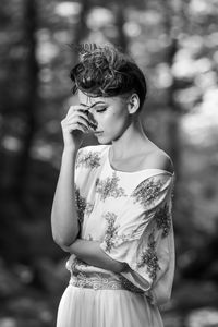 Portrait of young woman standing outdoors