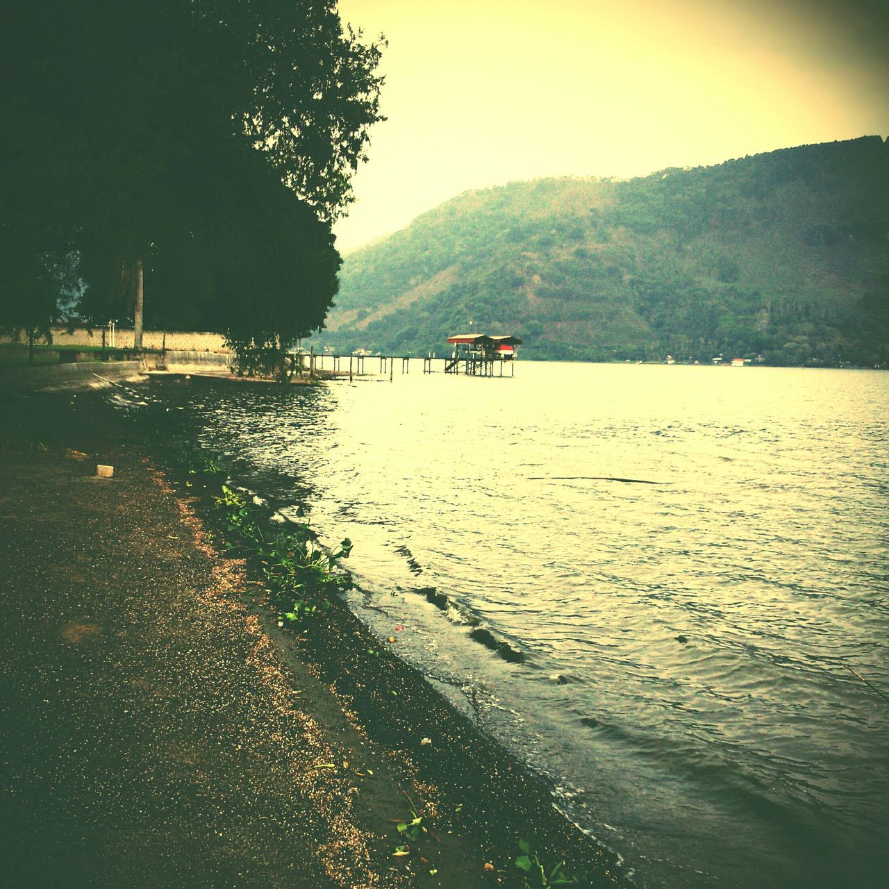 water, mountain, tranquil scene, tree, tranquility, scenics, sea, transportation, nautical vessel, beauty in nature, nature, boat, beach, mode of transport, incidental people, lake, river, sky, shore, idyllic