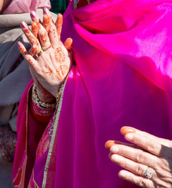 Close-up midsection of woman with hands clasped praying