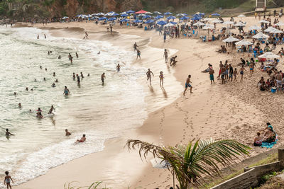 Large group of people on paciencia beach in the rio vermelho neighborhood of salvador, brazil. 