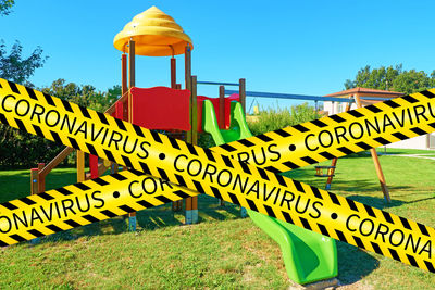 Information sign on field against sky