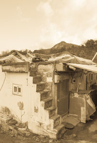 Houses on mountain against sky