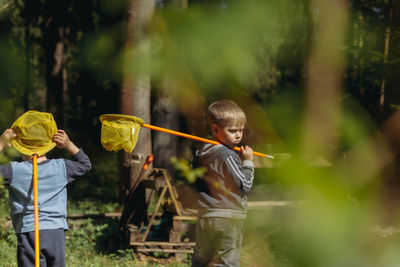 Little boys with butterfly nets in countryside. image with selective focus