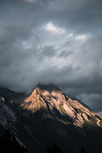 Scenic view of mountains against cloudy sky