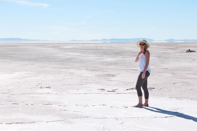 Rear view of woman standing on beach