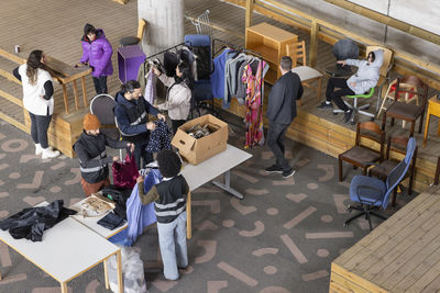 High angle view of workers and customers at recycling center