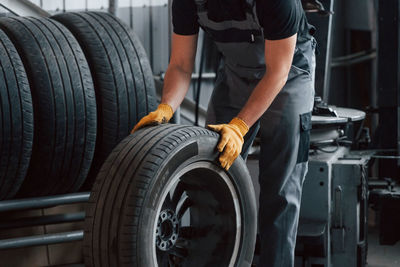  man in uniform is working in the auto service.