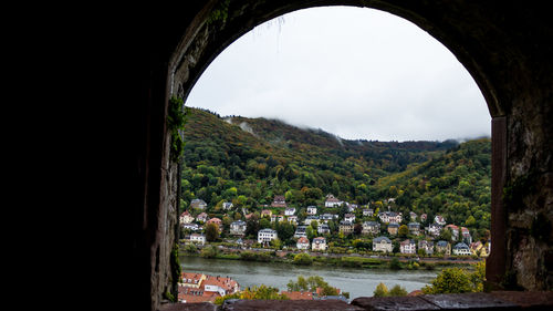 Arch bridge over river amidst buildings